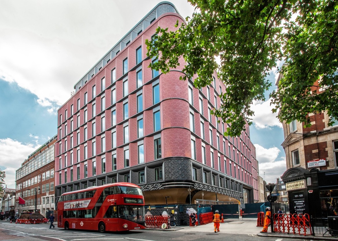 The pink-red exterior of the Skyscanner building in London